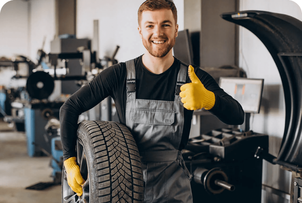 image (9) tire shop employee gesturing thumbs up